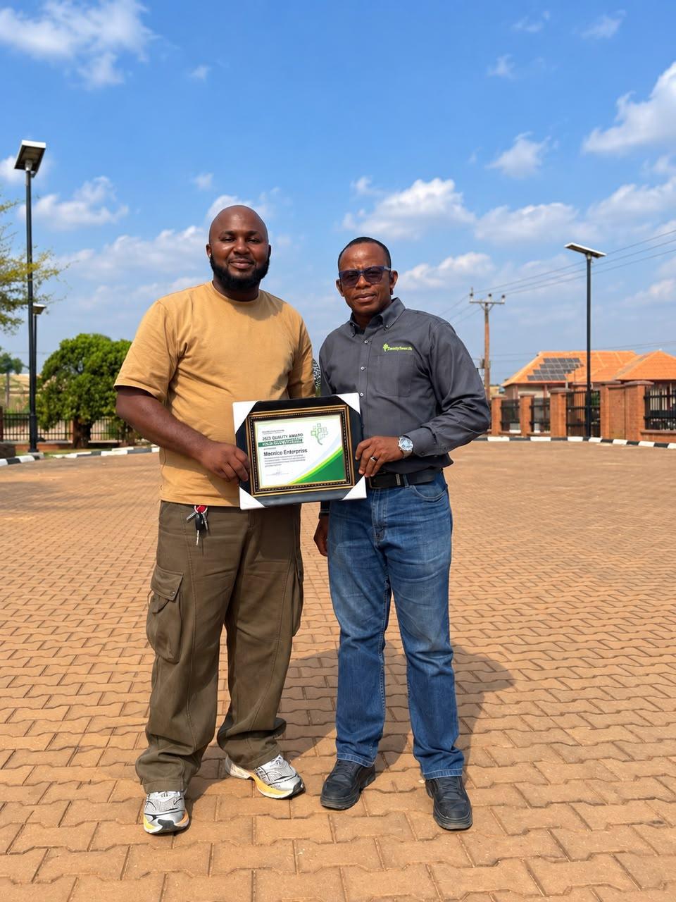 Ikegbunem Ugochukwu receiving the FamilySearch quality award with country manager Engr. Ogbonnaya Okoro